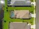 An aerial view showcasing a home's location, pool, and proximity to a canal at 4704 Foxtail Dr, Parrish, FL 34219