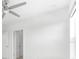 Simple bedroom with gray carpet, ceiling fan and door to another room at 4704 Foxtail Dr, Parrish, FL 34219