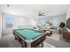 Upstairs game room with pool table and comfortable seating area at 4704 Foxtail Dr, Parrish, FL 34219