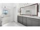 Double vanity bathroom with gray cabinets and granite countertops at 4704 Foxtail Dr, Parrish, FL 34219