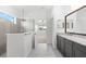 Modern bathroom with gray cabinetry, granite countertops, and a walk-in shower at 4704 Foxtail Dr, Parrish, FL 34219