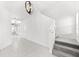 Bright entryway with tile floors and modern light fixture leading to the stairs at 4704 Foxtail Dr, Parrish, FL 34219