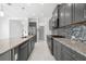 Modern kitchen with granite countertops and gray cabinets at 4704 Foxtail Dr, Parrish, FL 34219