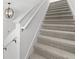 Modern staircase with gray carpeting and a clean, simple design at 4704 Foxtail Dr, Parrish, FL 34219