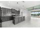 Modern kitchen with island, opens to Gathering room with pool view at 4704 Foxtail Dr, Parrish, FL 34219