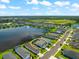 An aerial view of a house and community, highlighting its location near a lake and other homes at 4704 Foxtail Dr, Parrish, FL 34219