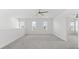 Spacious loft bedroom with carpet, ceiling fan, and multiple windows at 4704 Foxtail Dr, Parrish, FL 34219