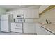 White kitchen with appliances, ample cabinets and counter space at 508 Woodstork Cir, Bradenton, FL 34209