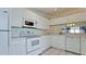 Bright kitchen featuring white cabinets and appliances at 508 Woodstork Cir, Bradenton, FL 34209
