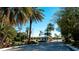 Gated entrance to community with tropical landscaping at 508 Woodstork Cir, Bradenton, FL 34209