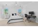 Bright bedroom with a queen-size bed and built-in workspace at 5919 Gulf Of Mexico Dr, Longboat Key, FL 34228