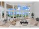Living room with expansive ocean views and pool access at 5919 Gulf Of Mexico Dr, Longboat Key, FL 34228