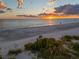 Tranquil beach scene with a couple enjoying the sunset at 5919 Gulf Of Mexico Dr, Longboat Key, FL 34228