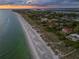 Breathtaking aerial view of beachfront properties along the coastline at sunset at 5919 Gulf Of Mexico Dr, Longboat Key, FL 34228