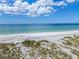 Wide sandy beach with crystal clear water, ideal for swimming, paddle boarding, and relaxation at 5919 Gulf Of Mexico Dr, Longboat Key, FL 34228