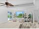Serene bedroom with ocean views, a ceiling fan, and access to the outdoor pool area at 5919 Gulf Of Mexico Dr, Longboat Key, FL 34228