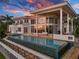 Luxury home with a vanishing edge pool overlooking ocean views at sunset at 5919 Gulf Of Mexico Dr, Longboat Key, FL 34228