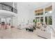 Spacious living room with high ceilings, marble floors, and ample natural light at 5919 Gulf Of Mexico Dr, Longboat Key, FL 34228