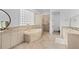 Elegant bathroom with soaking tub, double vanity, and glass block feature wall at 5919 Gulf Of Mexico Dr, Longboat Key, FL 34228