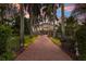 Elegant home entry with brick driveway and gated entrance at 5919 Gulf Of Mexico Dr, Longboat Key, FL 34228