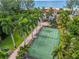 Private tennis court with lush landscaping and ocean views at 5919 Gulf Of Mexico Dr, Longboat Key, FL 34228