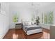 Bright bedroom with hardwood floors, plantation shutters and plush bedding at 5919 Gulf Of Mexico Dr, Longboat Key, FL 34228