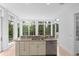Kitchen with granite countertops, white cabinets, and a view to the backyard at 5919 Gulf Of Mexico Dr, Longboat Key, FL 34228