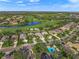 Expansive aerial view of a residential area with a golf course, lake and neighborhood at 7139 Sandhills Pl, Lakewood Ranch, FL 34202