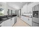 Kitchen featuring stainless steel appliances, white cabinets and a tiled backsplash at 7139 Sandhills Pl, Lakewood Ranch, FL 34202