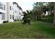 Landscaped backyard with lush grass and palm trees at 7201 29Th Avenue W Dr # 306, Bradenton, FL 34209