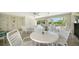 Community pool area with tables and chairs for relaxing at 766 N Jefferson Ave # 766, Sarasota, FL 34237