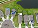 Aerial view showcasing homes with solar panels and a community lake at 8220 Reefbay Cv, Parrish, FL 34219