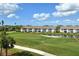 Community overview showcasing buildings near a golf course and pond at 9630 Club South Cir # 6303, Sarasota, FL 34238