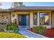 House exterior with teal door, bay window, and landscaping at 105 Hourglass Dr, Venice, FL 34293