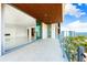 Large balcony showcasing ocean and city skyline views, connecting seamlessly to a modern living space at 111 Golden Gate Pt # 602, Sarasota, FL 34236