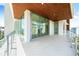 Spacious balcony with glass railings, offering views of buildings and neighborhood at 111 Golden Gate Pt # 602, Sarasota, FL 34236