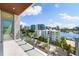 A spacious balcony overlooking the city and water boasts glass railings and bright sunlight at 111 Golden Gate Pt # 602, Sarasota, FL 34236