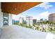 Outdoor balcony showing palm trees and a neighborhood view with modern high rise buildings on a clear day at 111 Golden Gate Pt # 602, Sarasota, FL 34236