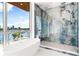 Elegant bathroom featuring designer tiled shower, a soaking tub, and a stunning city view at 111 Golden Gate Pt # 602, Sarasota, FL 34236