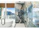 Elegant bathroom featuring designer tiled shower, a soaking tub, and a stunning city view at 111 Golden Gate Pt # 602, Sarasota, FL 34236