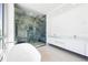 Luxurious bathroom featuring a soaking tub and a glass-enclosed shower with designer tile at 111 Golden Gate Pt # 602, Sarasota, FL 34236