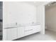 Modern bathroom featuring a double vanity with sleek white cabinetry and fixtures at 111 Golden Gate Pt # 602, Sarasota, FL 34236