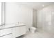 A modern bathroom is equipped with a glass walk-in shower and sleek white vanity at 111 Golden Gate Pt # 602, Sarasota, FL 34236