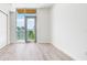 Sunlit empty bedroom featuring wood floors, a sliding glass door, and scenic outdoor views at 111 Golden Gate Pt # 602, Sarasota, FL 34236
