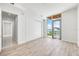 Well-lit bedroom with closet and balcony entrance with outside views of water and city at 111 Golden Gate Pt # 602, Sarasota, FL 34236