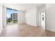 Spacious bedroom featuring hardwood floors and a large window with city views at 111 Golden Gate Pt # 602, Sarasota, FL 34236