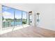 Light-filled bedroom showcasing expansive windows with stunning waterfront and city views at 111 Golden Gate Pt # 602, Sarasota, FL 34236