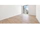 Bright, minimalist bedroom features hardwood floors and large windows offering city views at 111 Golden Gate Pt # 602, Sarasota, FL 34236