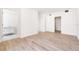 Minimalist bedroom features wood floors and ensuite bathroom with sleek modern design and ample closet space at 111 Golden Gate Pt # 602, Sarasota, FL 34236