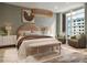 Staged bedroom featuring a warm color palette, stylish décor and lots of natural light at 111 Golden Gate Pt # 602, Sarasota, FL 34236